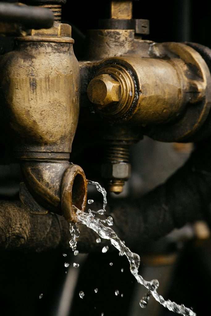 Water leaking from a brass pipe joint